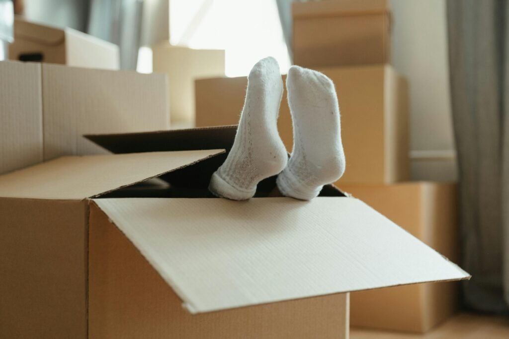 Moving Houses Blog - Feet sticking out of packaging box