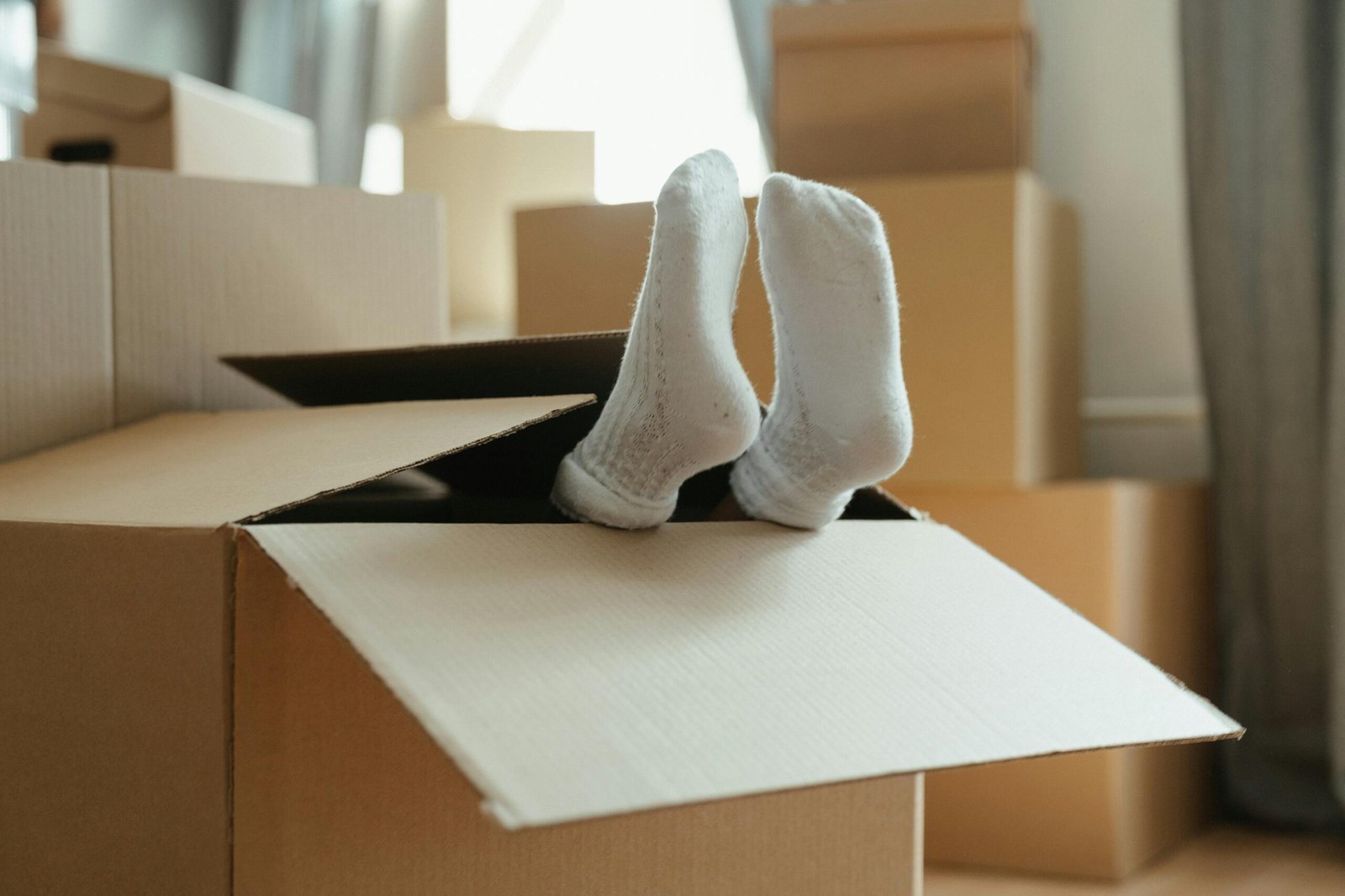 Moving Houses Blog - Feet sticking out of packaging box